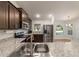 Spacious kitchen with granite countertops, stainless steel appliances, and dark wood cabinets at 8566 Se 156Th Pl, Summerfield, FL 34491