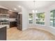 Modern kitchen and breakfast nook featuring stainless steel appliances and tiled floor at 8566 Se 156Th Pl, Summerfield, FL 34491
