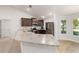 Updated kitchen with granite counters, stainless appliances, and hardwood-style flooring at 8566 Se 156Th Pl, Summerfield, FL 34491