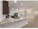 Bright kitchen with stainless steel appliances, dark cabinetry, and a granite countertop island at 8566 Se 156Th Pl, Summerfield, FL 34491