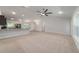 Bright, open living room with carpeted floors, neutral walls, and ceiling fan at 8566 Se 156Th Pl, Summerfield, FL 34491