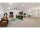 Spacious living room features a ceiling fan, open kitchen, and plenty of natural light at 8566 Se 156Th Pl, Summerfield, FL 34491