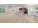 Expansive living area with vaulted ceilings, seamlessly connecting to the modern kitchen at 8566 Se 156Th Pl, Summerfield, FL 34491