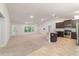 Open-concept living space featuring a kitchen with modern appliances and abundant natural light at 8566 Se 156Th Pl, Summerfield, FL 34491