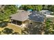 Aerial view of the home's back patio, backyard, and lush foliage surrounding the property at 8566 Se 156Th Pl, Summerfield, FL 34491