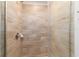 Bathroom features a glass-enclosed shower with wood-look tiling, shower head, and soap dish at 8566 Se 156Th Pl, Summerfield, FL 34491