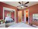 Bedroom with mirrored closet doors and ceiling fan at 5414 Meadow Hill Loop, Lady Lake, FL 32159