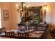 Formal dining room with a rustic table and detailed chandelier at 5414 Meadow Hill Loop, Lady Lake, FL 32159