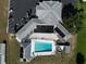 Overhead aerial view of community clubhouse with sparkling pool and nearby parking at 1209 Apache Cir, Tavares, FL 32778