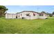 View of the back of the house and large yard at 1209 Apache Cir, Tavares, FL 32778