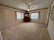 Bright bedroom featuring neutral carpet, ceiling fan, and natural light at 1209 Apache Cir, Tavares, FL 32778