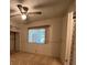 Bedroom featuring neutral carpet, ceiling fan, and ample natural light at 1209 Apache Cir, Tavares, FL 32778