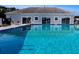 Inviting community pool with clear blue water, lounge chairs, and a well-maintained pool deck at 1209 Apache Cir, Tavares, FL 32778