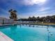 Beautiful community pool with clear water, surrounded by lounge chairs, with views of the lake at 1209 Apache Cir, Tavares, FL 32778