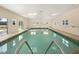 Indoor pool with easy access steps and natural light, perfect for year-round enjoyment in a community recreation center at 1209 Apache Cir, Tavares, FL 32778