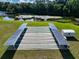 Multiple shuffleboard courts offer a fantastic recreational area, surrounded by lush greenery and a tranquil lake at 1209 Apache Cir, Tavares, FL 32778