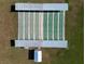 Aerial view of multiple well-maintained shuffleboard courts, providing an ideal recreational amenity for the community at 1209 Apache Cir, Tavares, FL 32778