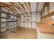 Bright storage room with open shelving, wood countertops, white walls and ceiling, and a single window at 1209 Apache Cir, Tavares, FL 32778