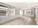 Open sunroom featuring tile flooring, large windows, and neutral walls at 1209 Apache Cir, Tavares, FL 32778
