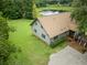 Aerial view of home with beautiful landscaping, a pond, and a peaceful setting at 26348 Se Highway 42, Umatilla, FL 32784