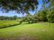 Expansive backyard with mature trees and a small outbuilding offers endless possibilities at 26348 Se Highway 42, Umatilla, FL 32784