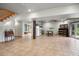 Finished basement featuring tile floors, a rustic desk, and a kitchenette with white appliances at 26348 Se Highway 42, Umatilla, FL 32784