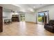 Bright, finished basement with tile flooring, a ceiling fan, and multiple sliding doors leading to the yard at 26348 Se Highway 42, Umatilla, FL 32784