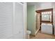 Bright bathroom features a wood accent wall, white vanity, tile floors, and glass enclosed shower at 26348 Se Highway 42, Umatilla, FL 32784