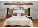Inviting bedroom features warm tones, a vaulted ceiling, and natural light from the surrounding windows at 26348 Se Highway 42, Umatilla, FL 32784
