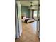 View of a bedroom with tile floors, a ceiling fan, and a view of the outside through an open door at 26348 Se Highway 42, Umatilla, FL 32784