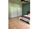 Cozy bedroom with warm tile floors, a ceiling fan, and two spacious closets at 26348 Se Highway 42, Umatilla, FL 32784