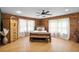 Comfortable bedroom with wood-paneled walls, hardwood floors, and a rustic, handcrafted bed frame at 26348 Se Highway 42, Umatilla, FL 32784