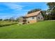 Beautiful home with a stone foundation, an expansive lawn, and a view of the surrounding countryside at 26348 Se Highway 42, Umatilla, FL 32784