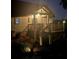 Exterior front view of home with covered porch and manicured landscaping at twilight at 26348 Se Highway 42, Umatilla, FL 32784