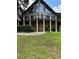 Attractive home featuring a stone foundation, a balcony, and a well-manicured lawn at 26348 Se Highway 42, Umatilla, FL 32784
