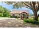 Quaint home with a welcoming front porch, gravel driveway, and lush landscaping at 26348 Se Highway 42, Umatilla, FL 32784