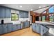 Bright kitchen features stainless steel appliances, light blue cabinets, and a view of the backyard at 26348 Se Highway 42, Umatilla, FL 32784