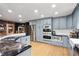 Modern kitchen featuring stainless steel appliances, light blue cabinets, and granite countertops at 26348 Se Highway 42, Umatilla, FL 32784