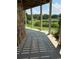 Relax on the covered patio with views of lush landscaping and serene pond at 26348 Se Highway 42, Umatilla, FL 32784
