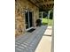 Stone patio features a grill and sliding door access to the home's interior at 26348 Se Highway 42, Umatilla, FL 32784