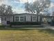 Charming single-story home with well-maintained lawn and mature trees for a peaceful setting at 512 Palo Verde Dr, Leesburg, FL 34748