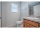 Neutral bathroom featuring a white toilet, shower, and wood vanity with a grey countertop at 3114 Jemima Ave, The Villages, FL 32163