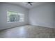 A bright bedroom with a ceiling fan and a window providing ample natural light at 3114 Jemima Ave, The Villages, FL 32163