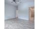 Bedroom with ensuite bathroom, ceiling fan, and wood-style flooring at 3114 Jemima Ave, The Villages, FL 32163