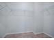 A walk-in closet with metal shelving and wood-look flooring offers ample storage space at 3114 Jemima Ave, The Villages, FL 32163