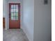 Entryway with a view of the stained glass front door, tile floors, and white walls at 3114 Jemima Ave, The Villages, FL 32163