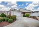 Charming single-story home with a two-car garage, landscaped front yard, and a paved driveway approaching the garage at 3114 Jemima Ave, The Villages, FL 32163
