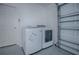 Laundry area featuring a white washer and dryer inside the garage at 3114 Jemima Ave, The Villages, FL 32163