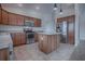 Spacious kitchen featuring an island, wooden cabinets, and stainless steel appliances at 3114 Jemima Ave, The Villages, FL 32163
