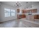 Bright kitchen features wood cabinets, stainless steel appliances, pendant lighting, and an island at 3114 Jemima Ave, The Villages, FL 32163